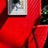 Poster on red wall with chair