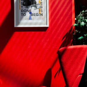 Poster on red wall with chair