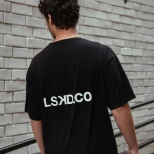 Black crew-neck tee by brick wall