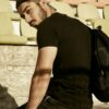 Black tee and pants, seated