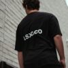 Man in black tee, white wall