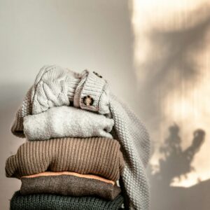 Stack of sweaters on chair