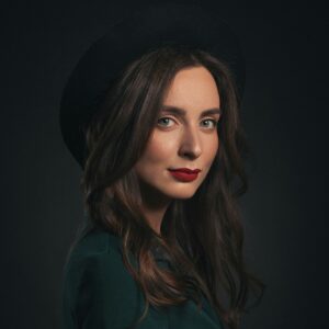 Woman in green shirt and hat