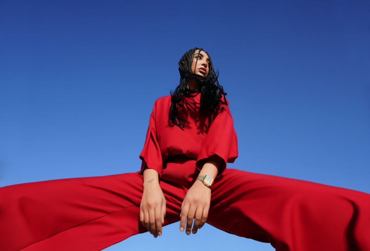 Woman in red against blue sky