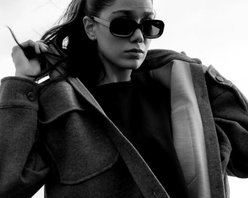 Woman in sunglasses and coat